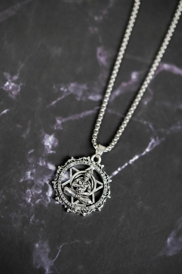 Silver oxidised stainless steel Shree Yantra with Hanuman Raksha pendant on chain on dark marble background