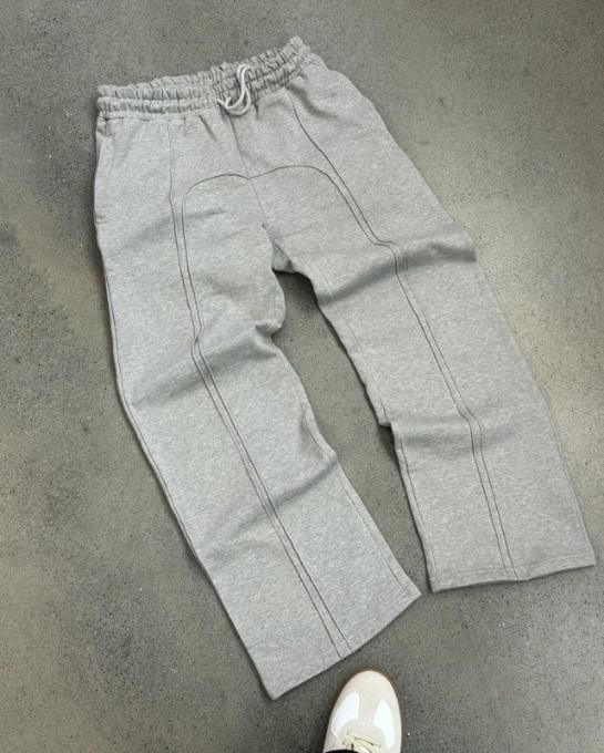 Men's elastic waist gray sweatpants with drawstring on concrete floor