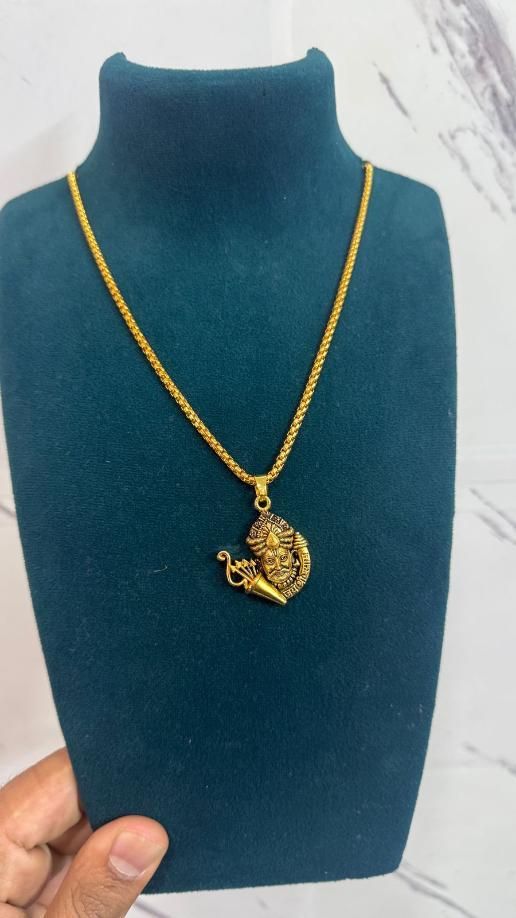 Golden Khatu Shyamji pendant with chain made of gold-plated stainless steel displayed on a black mannequin bust